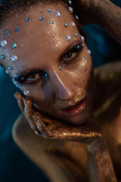 A close-up shot of a character skin, showcasing intricate details of the visual effects. Glowing particle effects are visible around the character's hands and weapon, enhancing the skin's visual appeal and highlighting the work in the new skin showcase: a detailed look at the visual effects and animations of new skins.